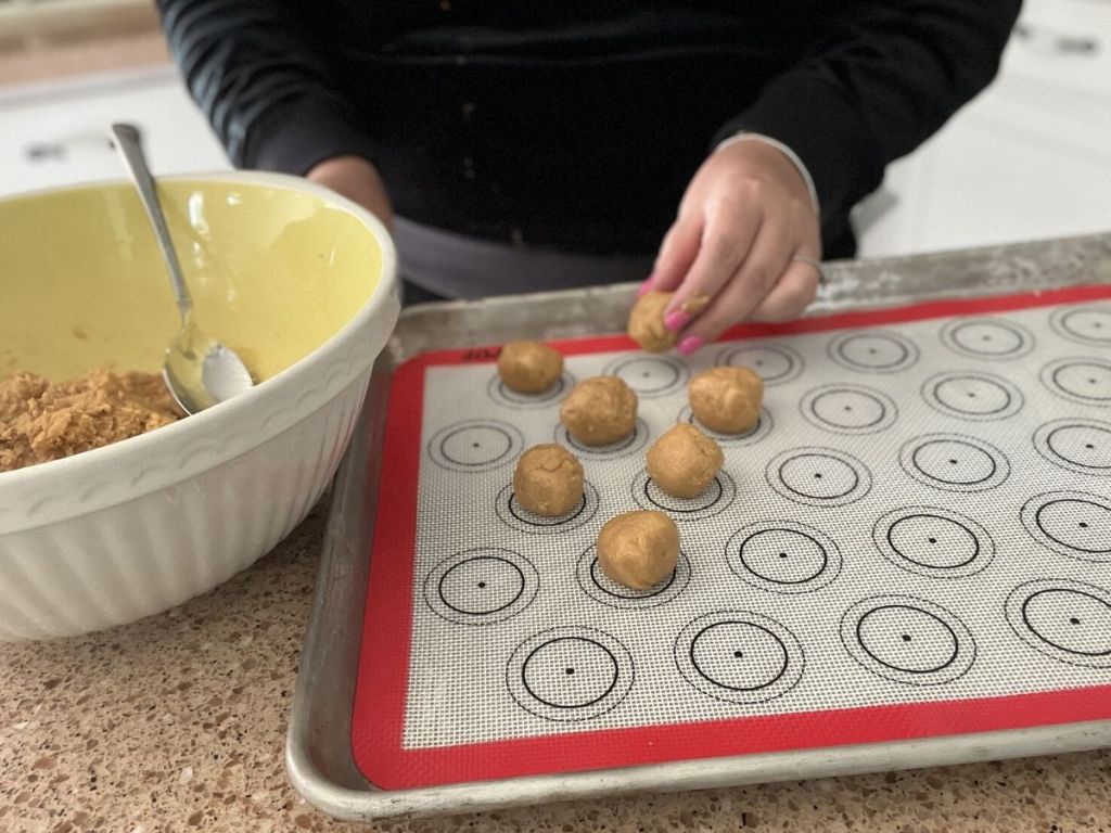 woman putting dough on silicone baking mats