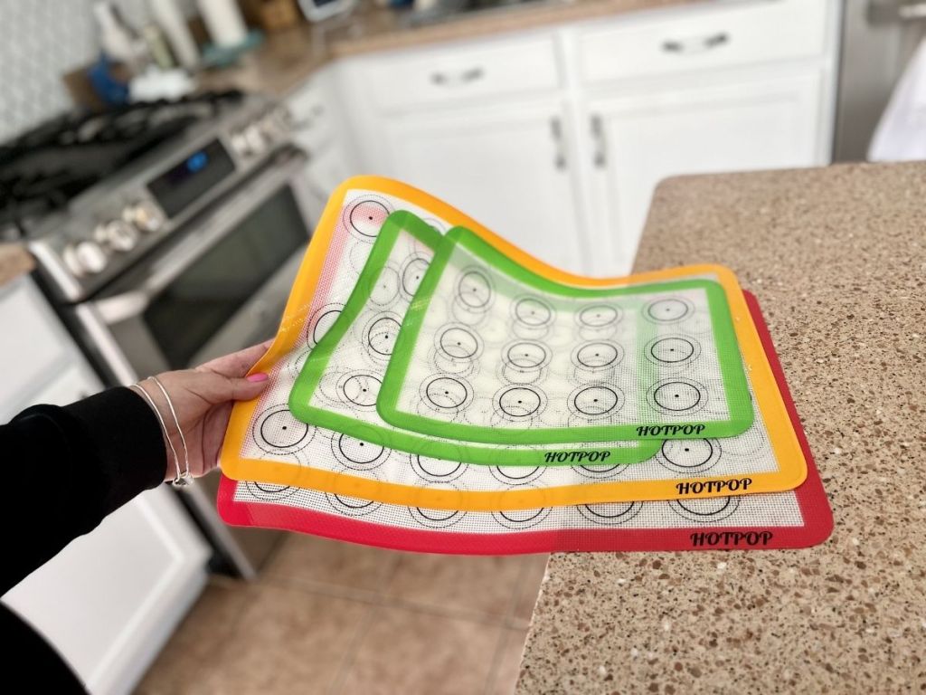 woman holding silicone baking mats