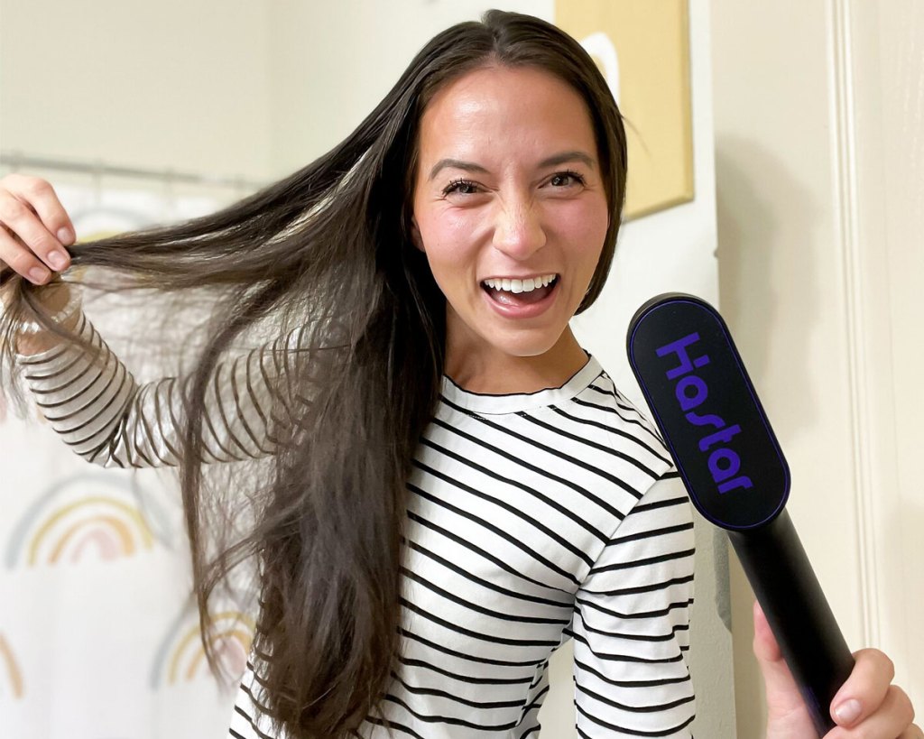 woman showing off hair and styling brush