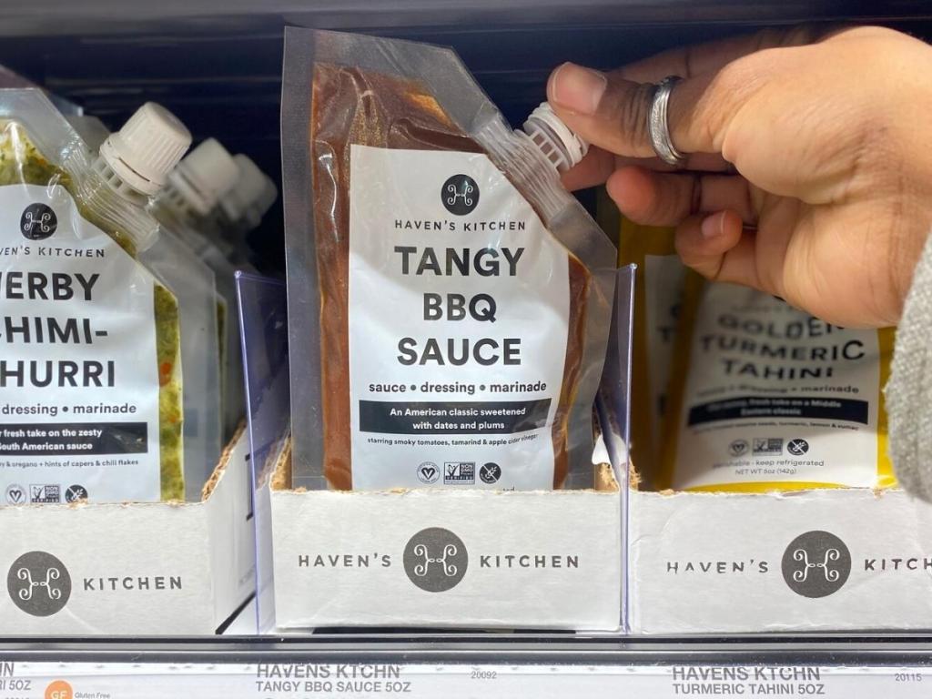 hand holding haven's kitchen plant based barbecue sauce