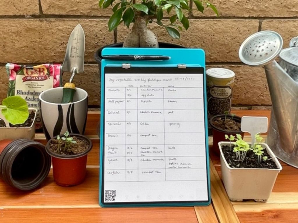 Rocketbook Orbit Legal Pad Executive - Smart Reusable Legal Pad - Teal, Lined/Dot-Grid shown being used to track gardening