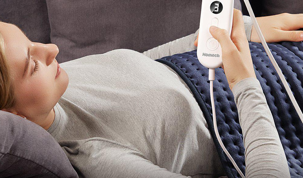 woman holding a heating pad control