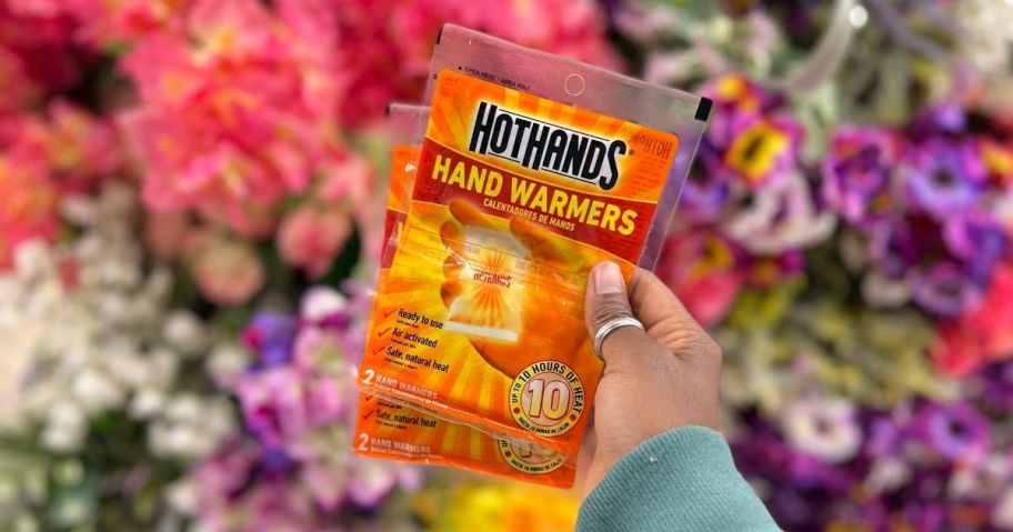 holding 2 packages of hand warmers