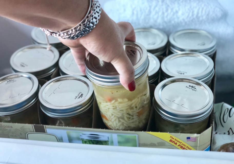 Placing a mason jar in a freezer to show how to freeze soup