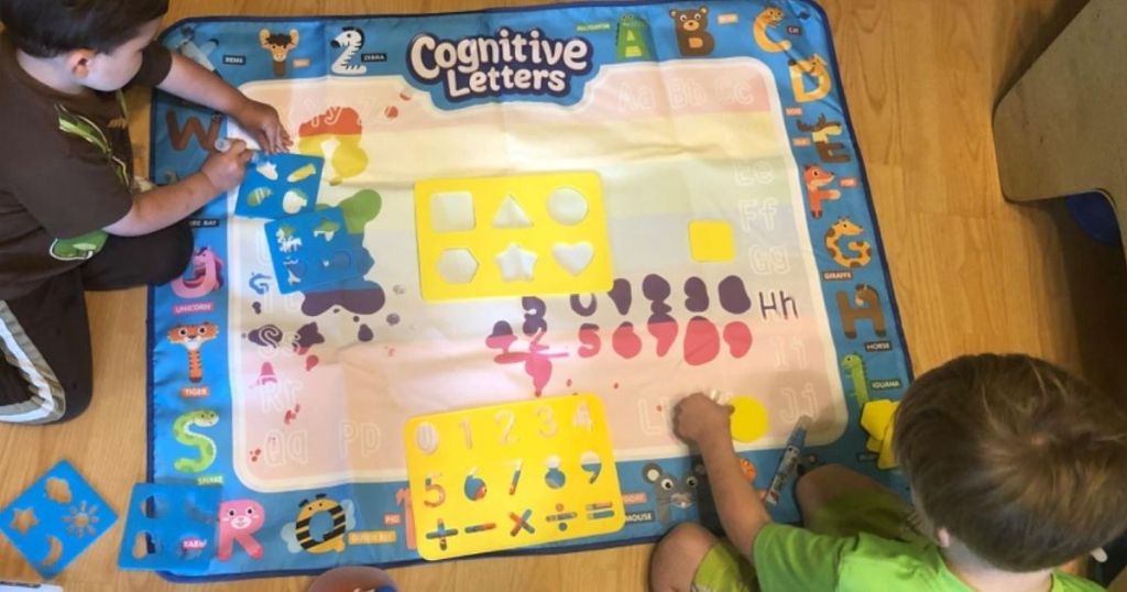 kids coloring on a doodle mat