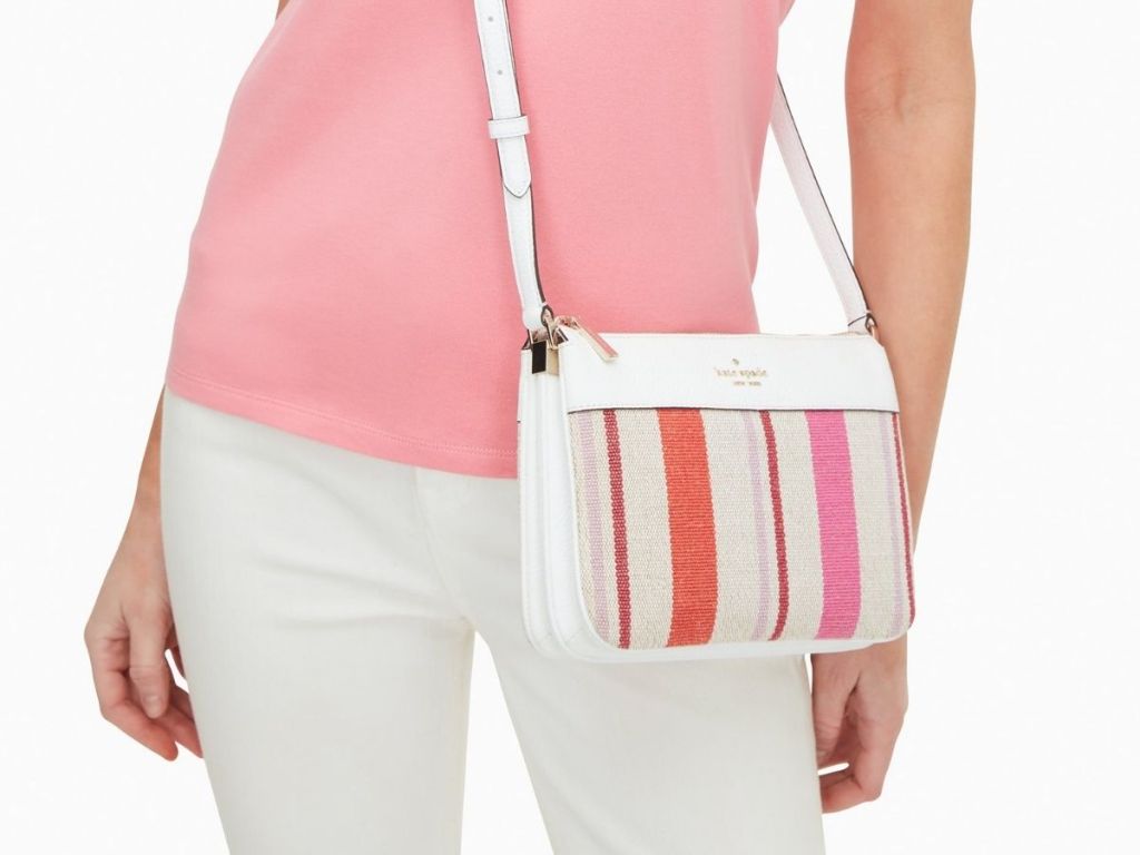 woman wearing white and color striped Kate Spade crossbody