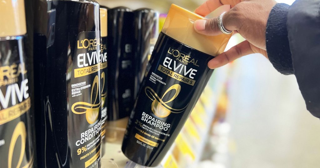 grabbing bottle of loreal elvive shampoo from store shelf