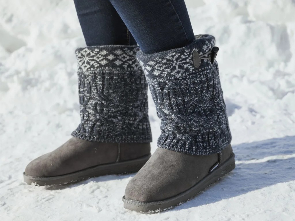 woman wearing gray sweater boots in snow