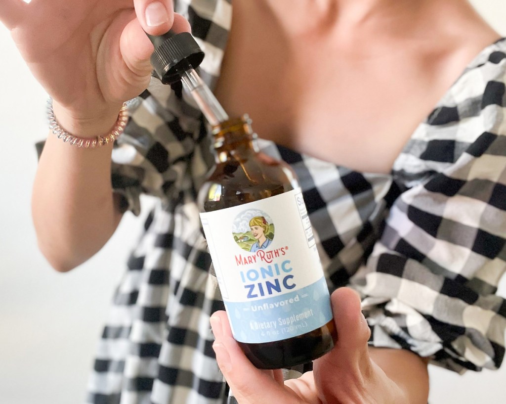 holding bottle of MaryRuth's Organics Ionic Zinc Liquid Drops