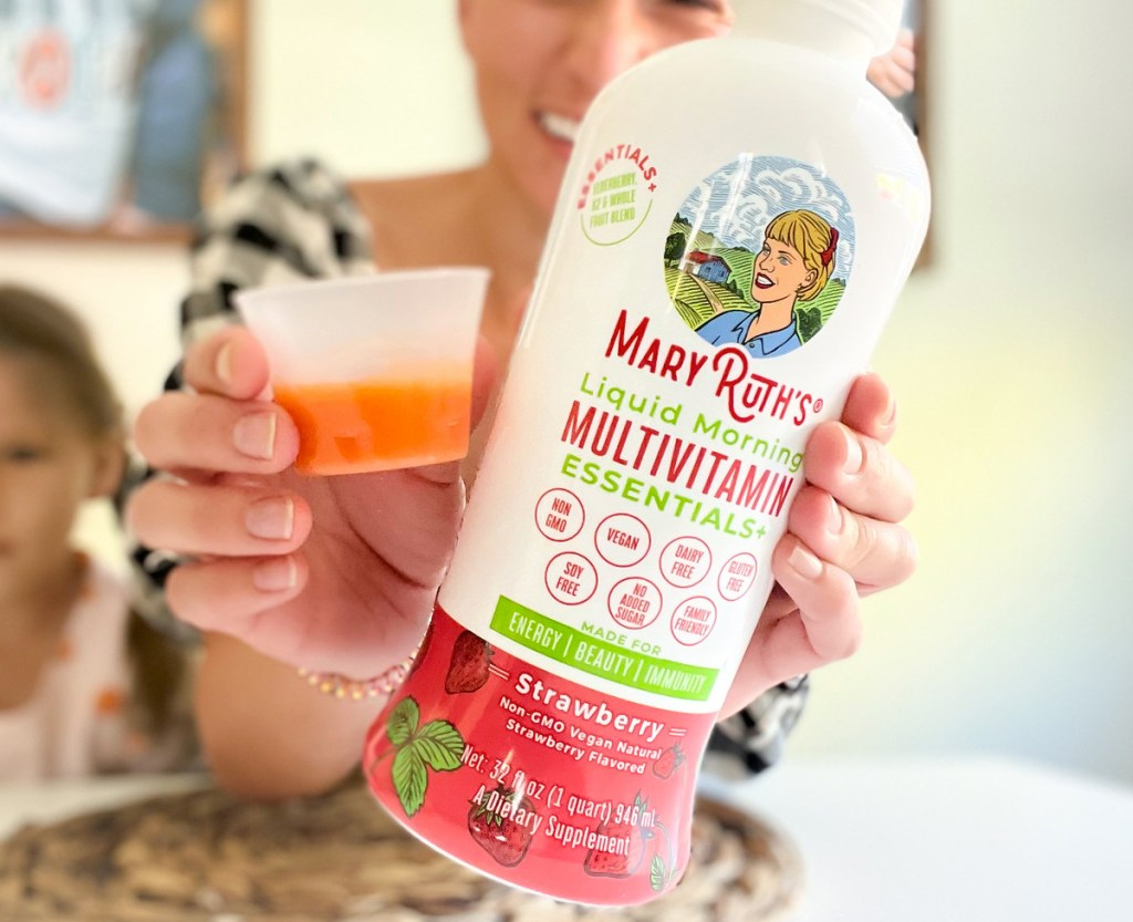 holding up MaryRuth's Organics Strawberry Liquid Morning Multivitamin