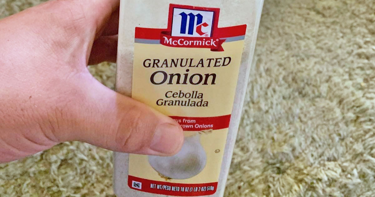 hand holding large bottle of McCormick Granulated Onion