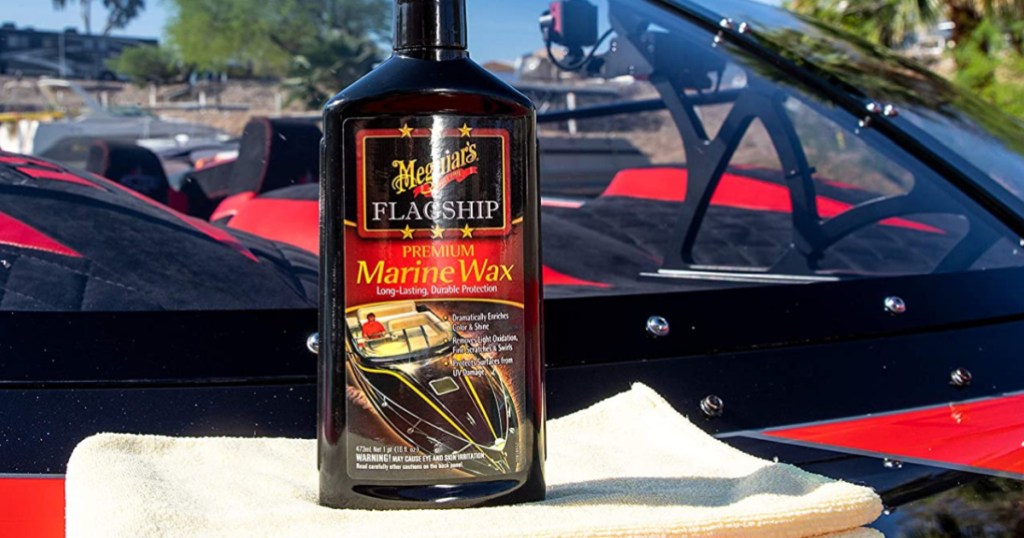 bottle of marine wax and cleaning cloth on boat