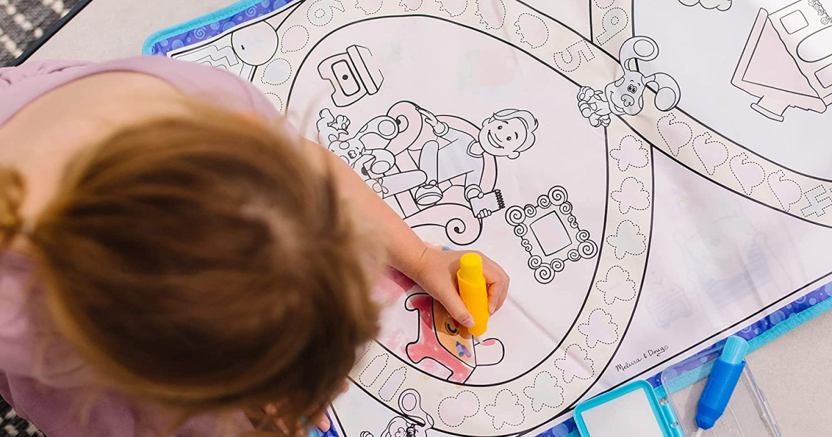 girl coloring on water activity mat