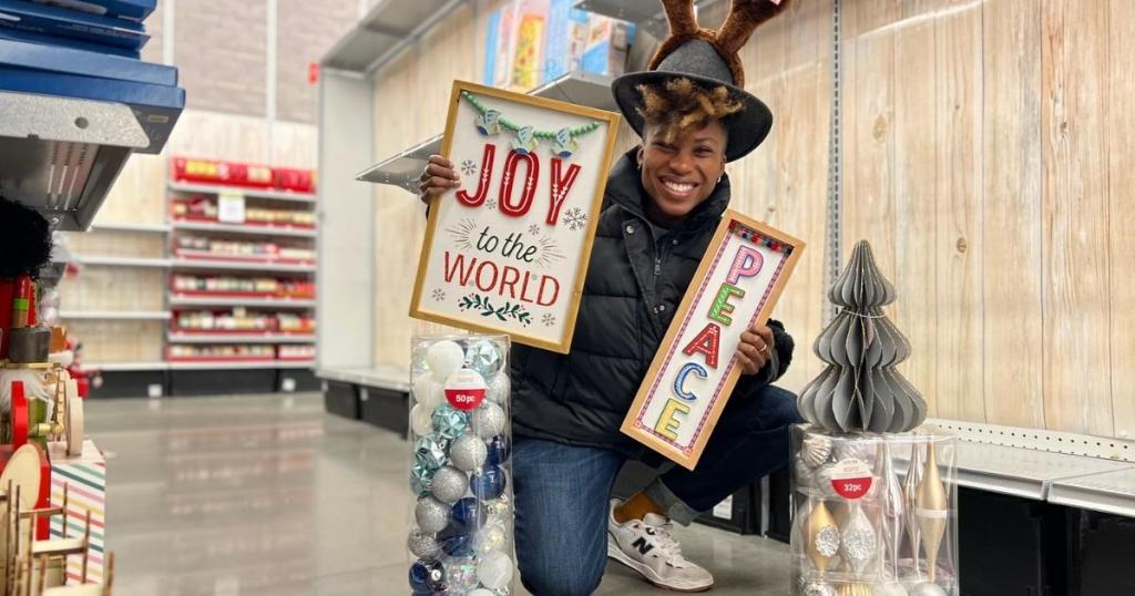 woman with michaels christmas decor in store