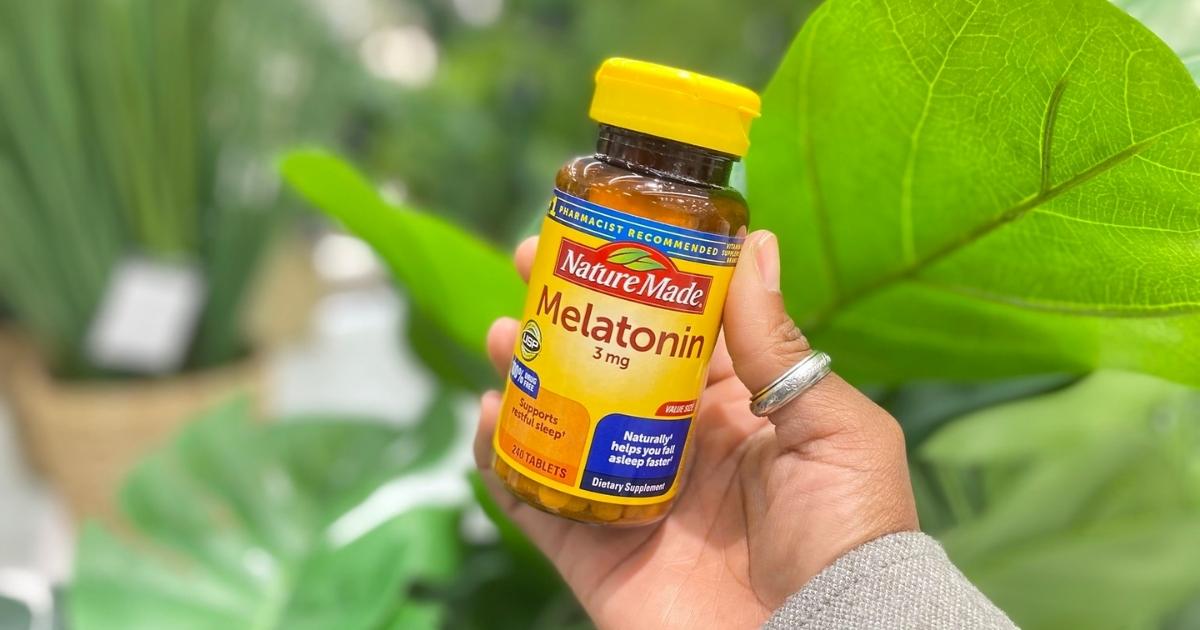 hand holding nature made melatonin tablets in store
