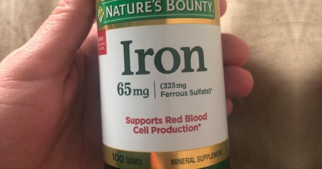 hand holding a bottle of Nature's Bounty iron