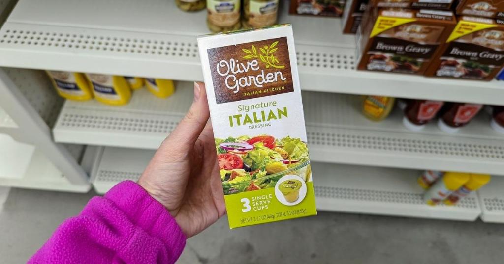 hand holding box of olive garden italian dressing single packs