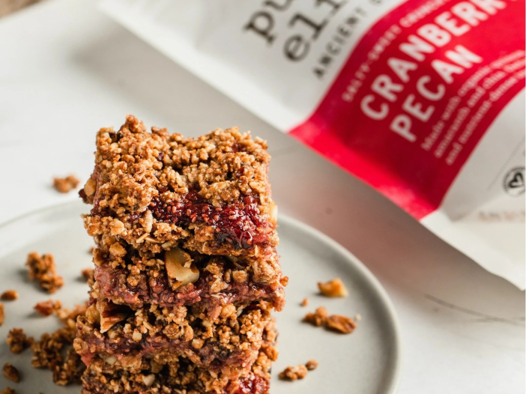 bag of cranberry granola and plate of granola bars