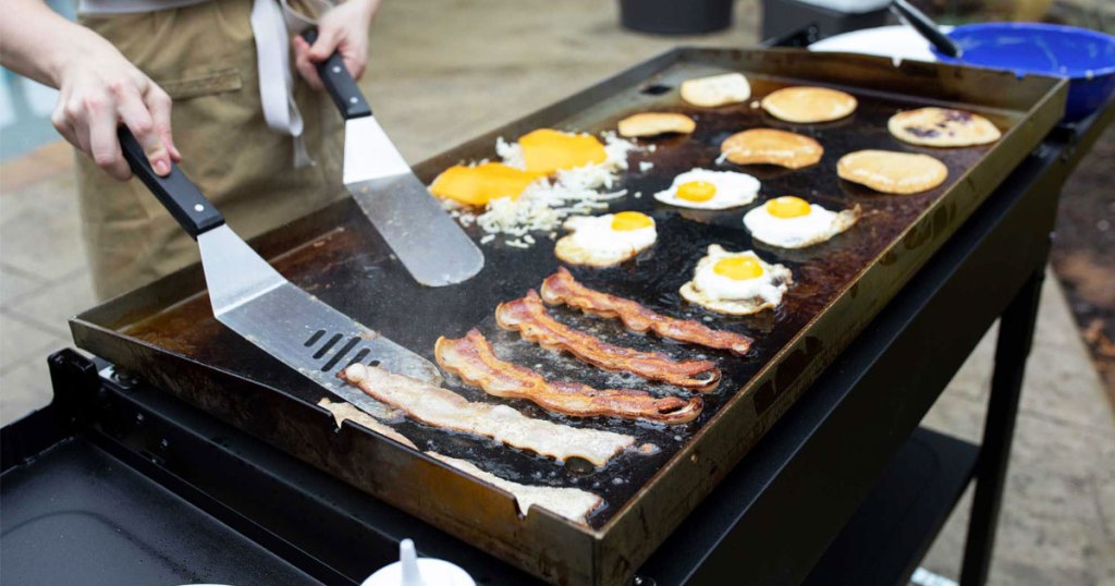 flipping bacon on a griddle