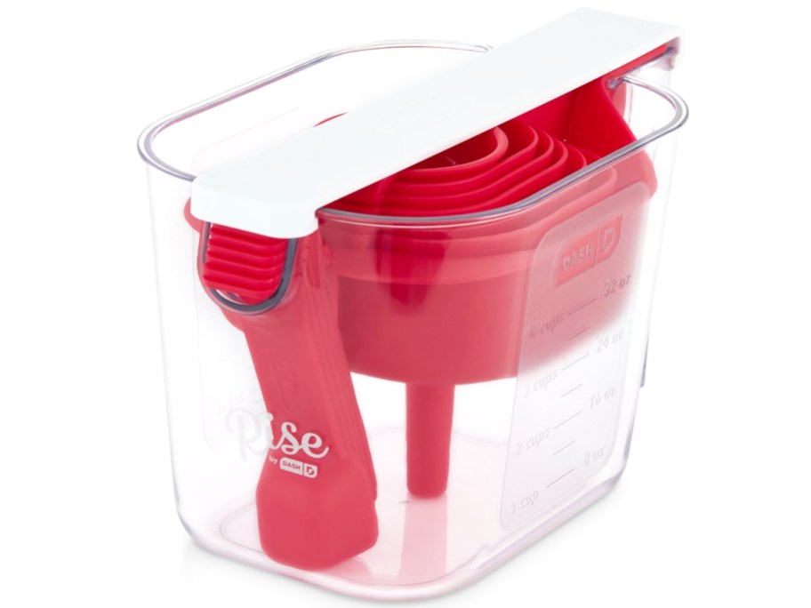 red measuring cup and spoons set nested into a liquid measuring cup