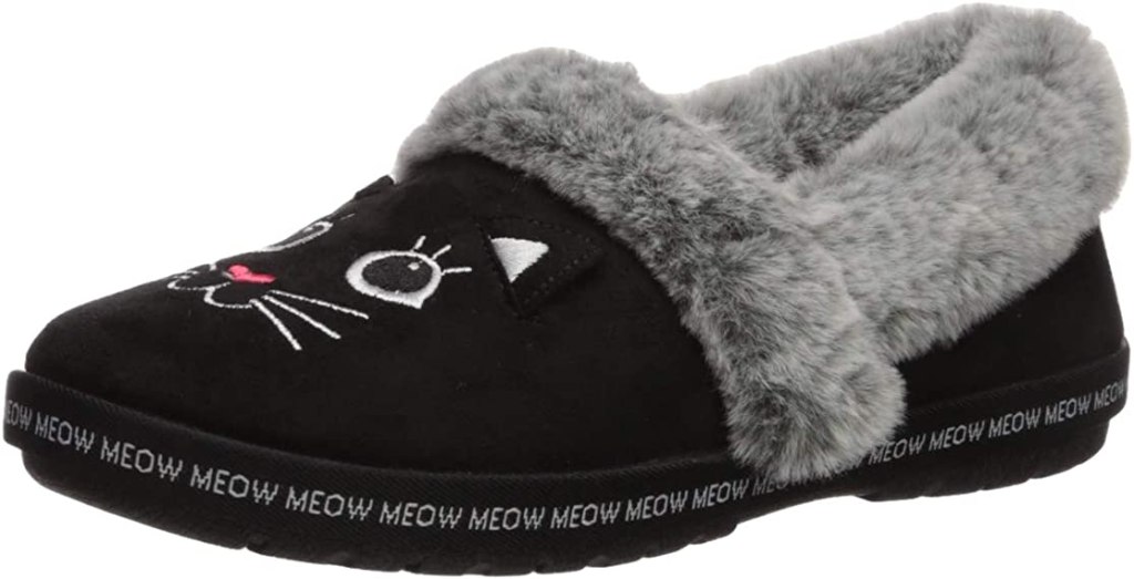 Black slipper with a cat face on the foot and a faux fur lining