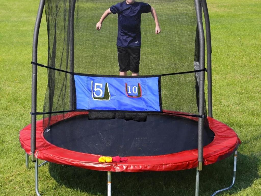 boy jumping on red skywalker trampoline