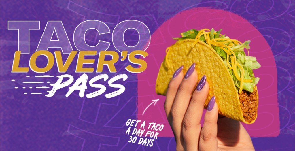 hand with purple fingernails holding a taco