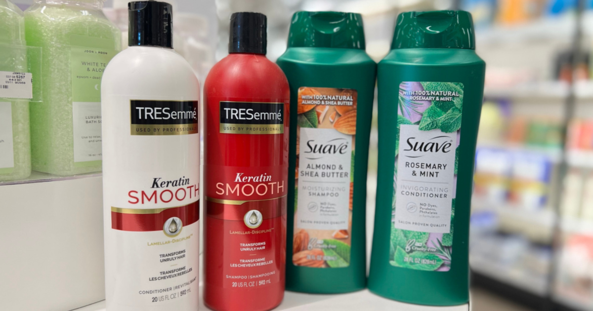four shampoo and conditioner bottles in store