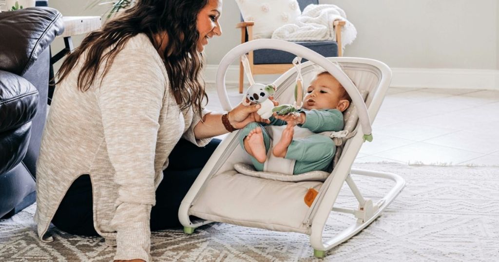 woman looking at a baby in a rocker