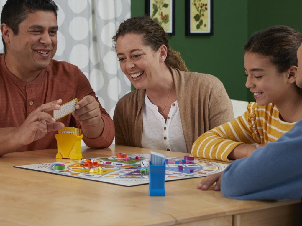 family playing board game on table