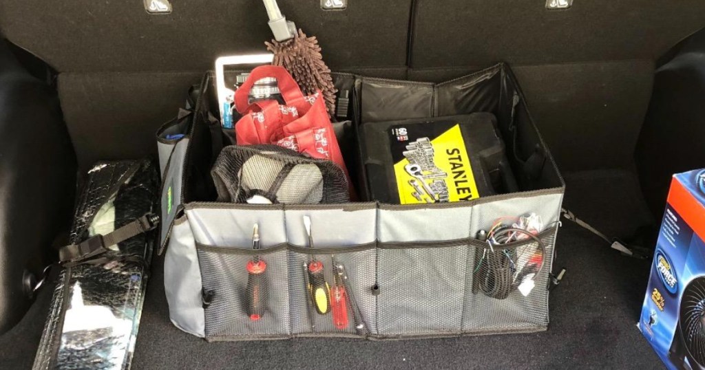 Trunk organizer filled with items in back of car