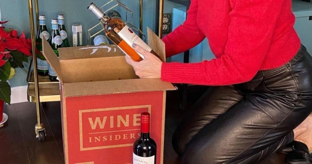 woman pulling wine bottles from Wine Insider box