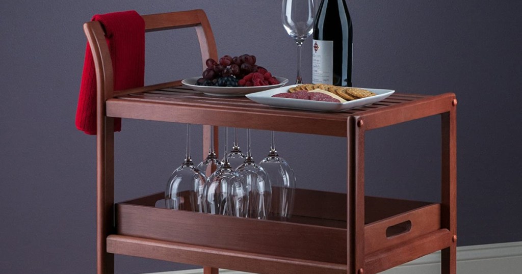 wine, wine glasses, and snacks on rolling kitchen cart
