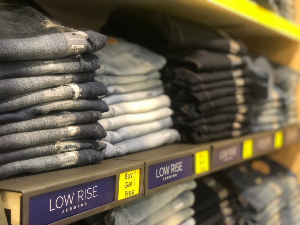 stack of jeans on store shelf