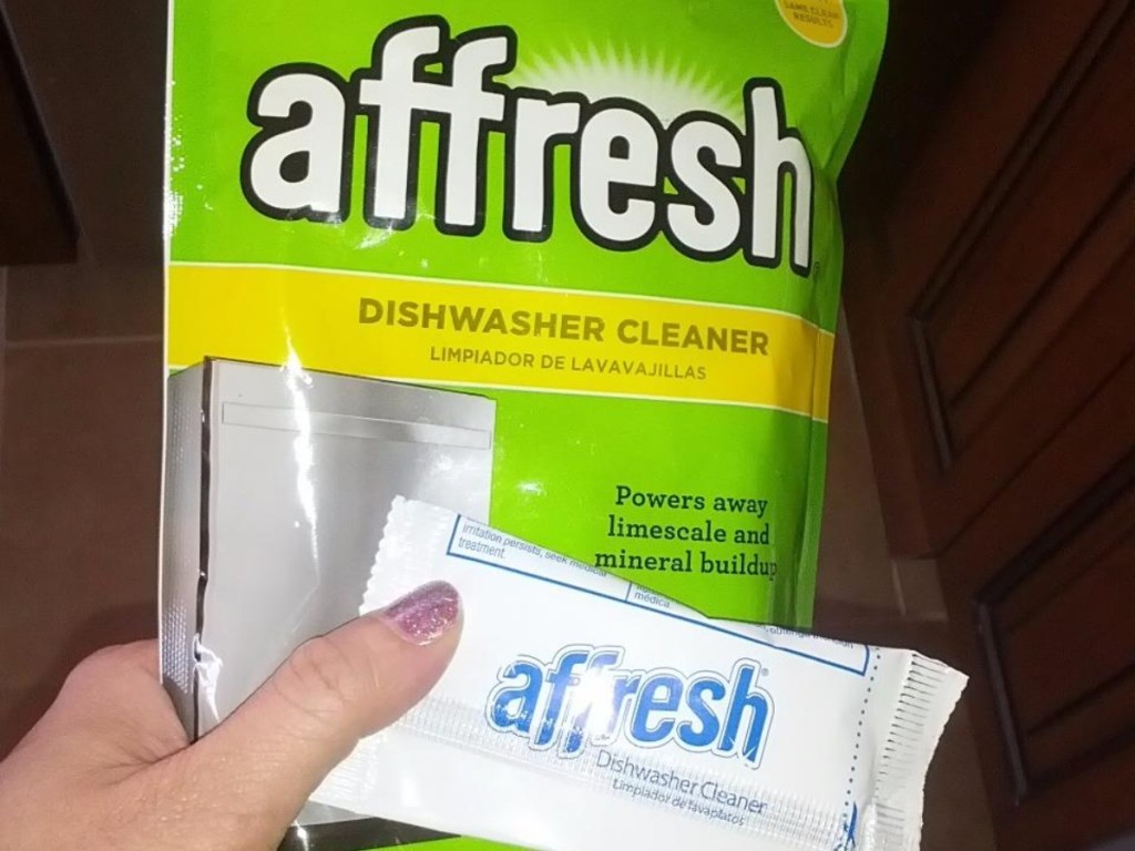 holding an affresh dishwasher cleaning tablet