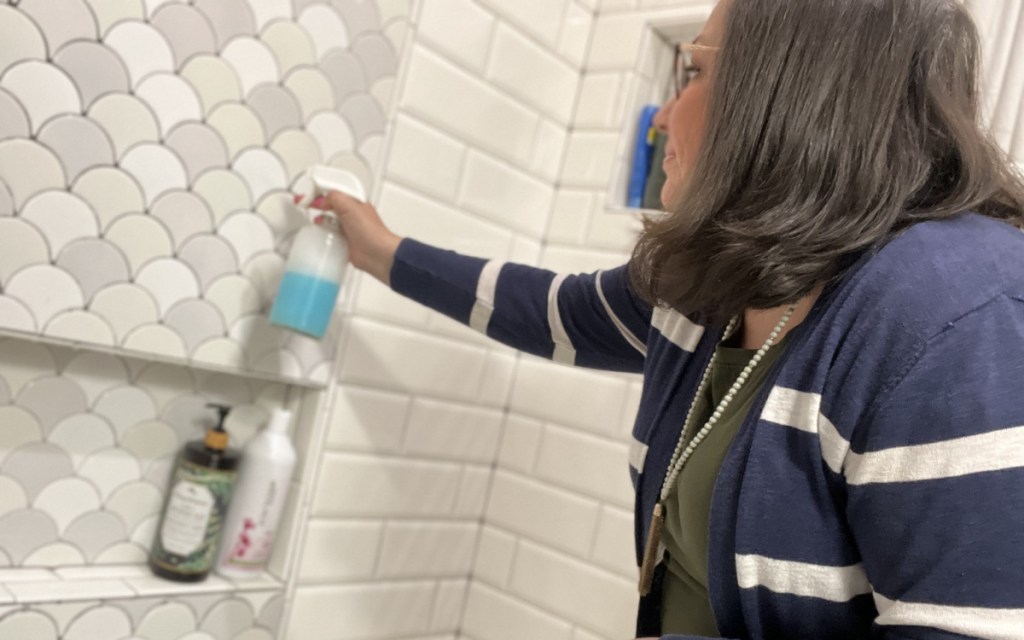 applying cleaner to tiles