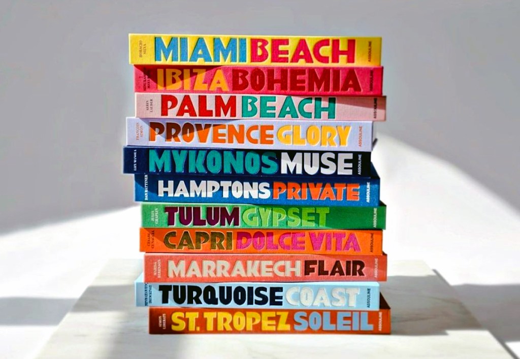 colorful and vibrant books stacked on top of each other on marble slab