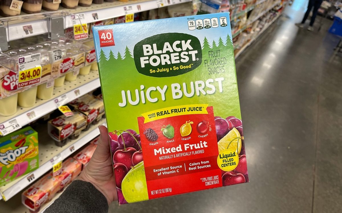holding a 40-count box of Black Forest fruit snacks