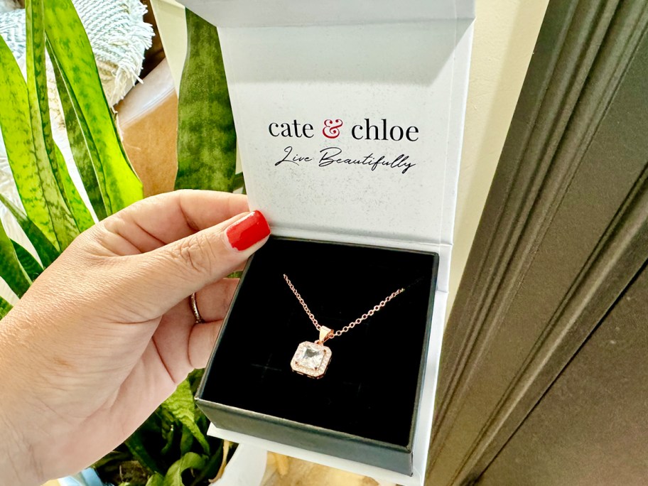 hand holding square necklace in giftbox