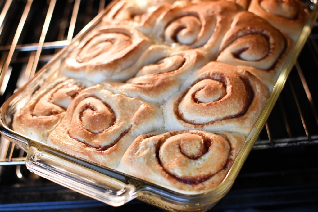 cinnamon rolls in the oven lightly browned