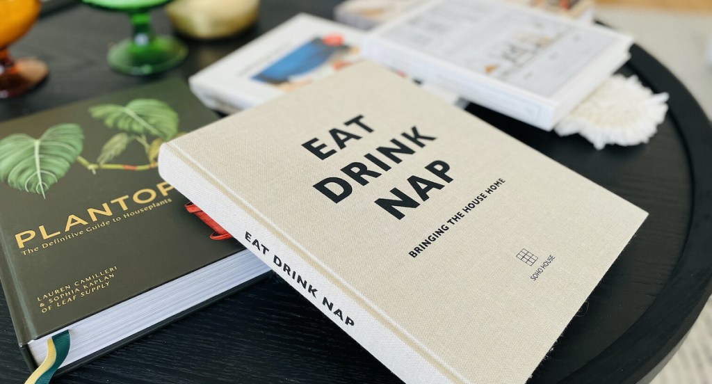 close up of eat drink nap book on black coffee table