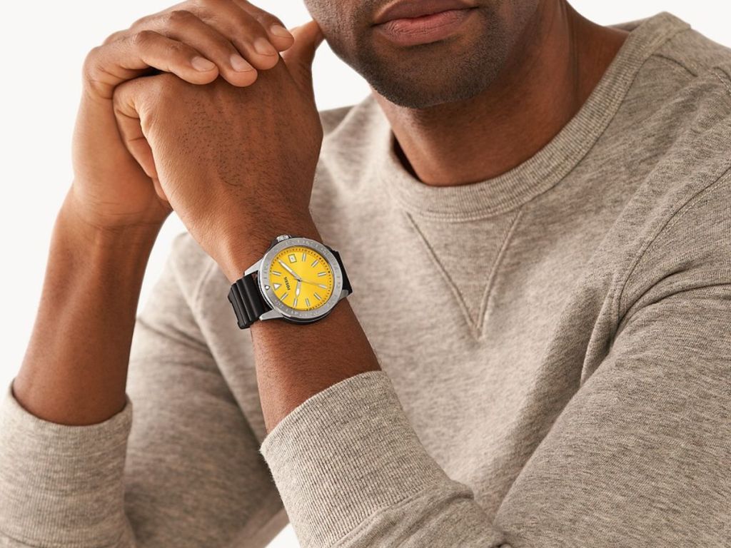 man wearing Fossil watch with black band and yellow face