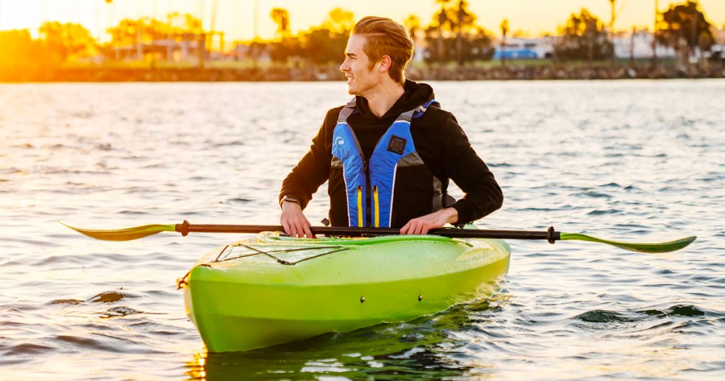 man in green kayak on water