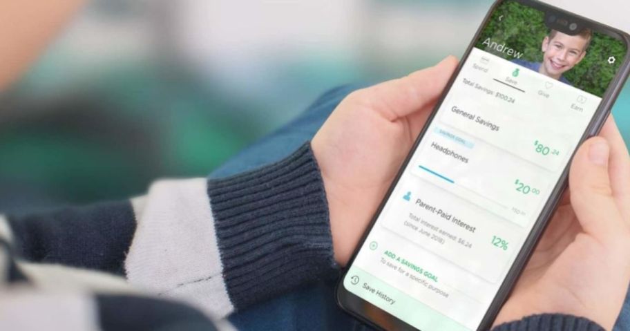 holding a cell phone with Greenlight app.