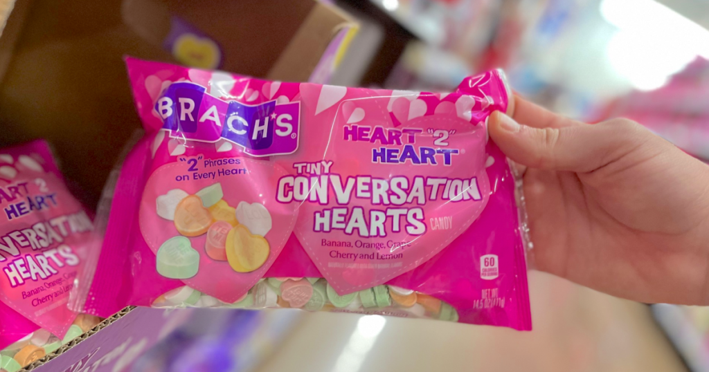 holding bag of Brach's Conversation Hearts 