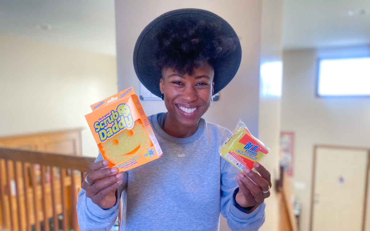 woman holding scrub daddy and dupe
