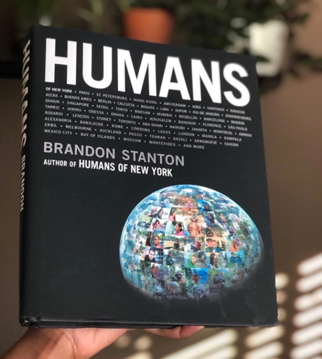 hand holding humans coffee table book