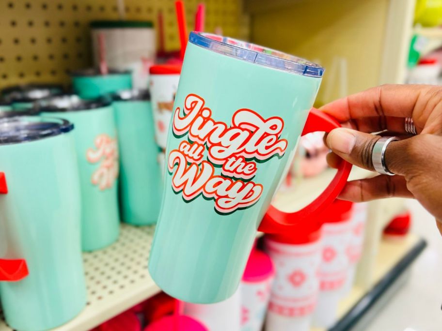 a womans hand holding an insulated tumbler