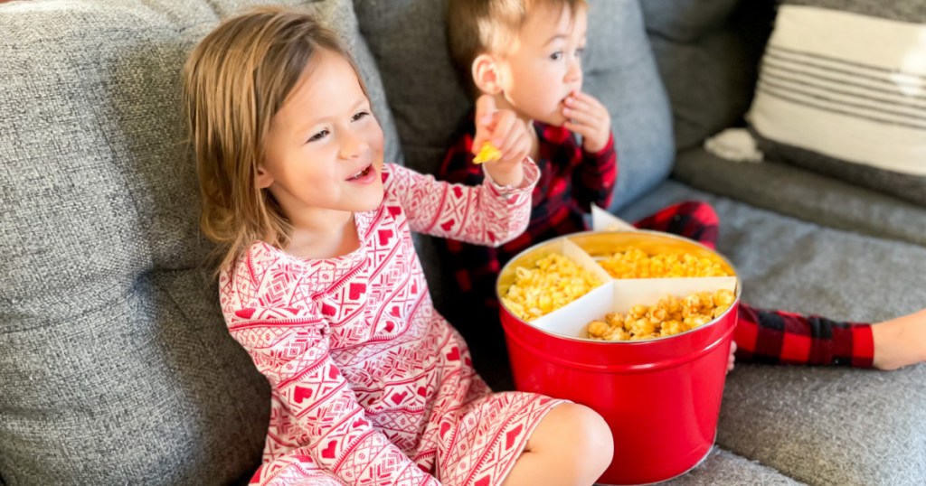 kids eating popcorn on couch
