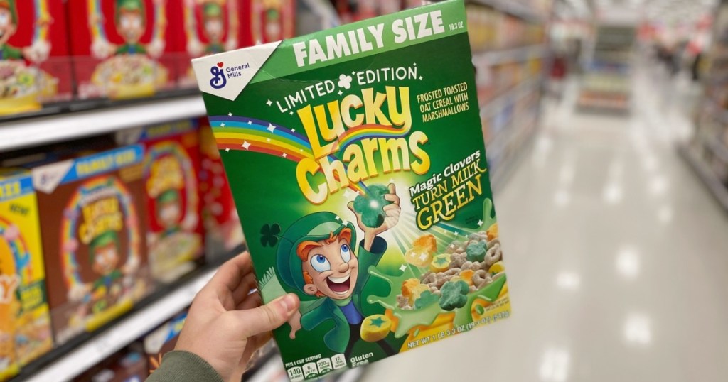 holding a box of Lucky Charms cereal